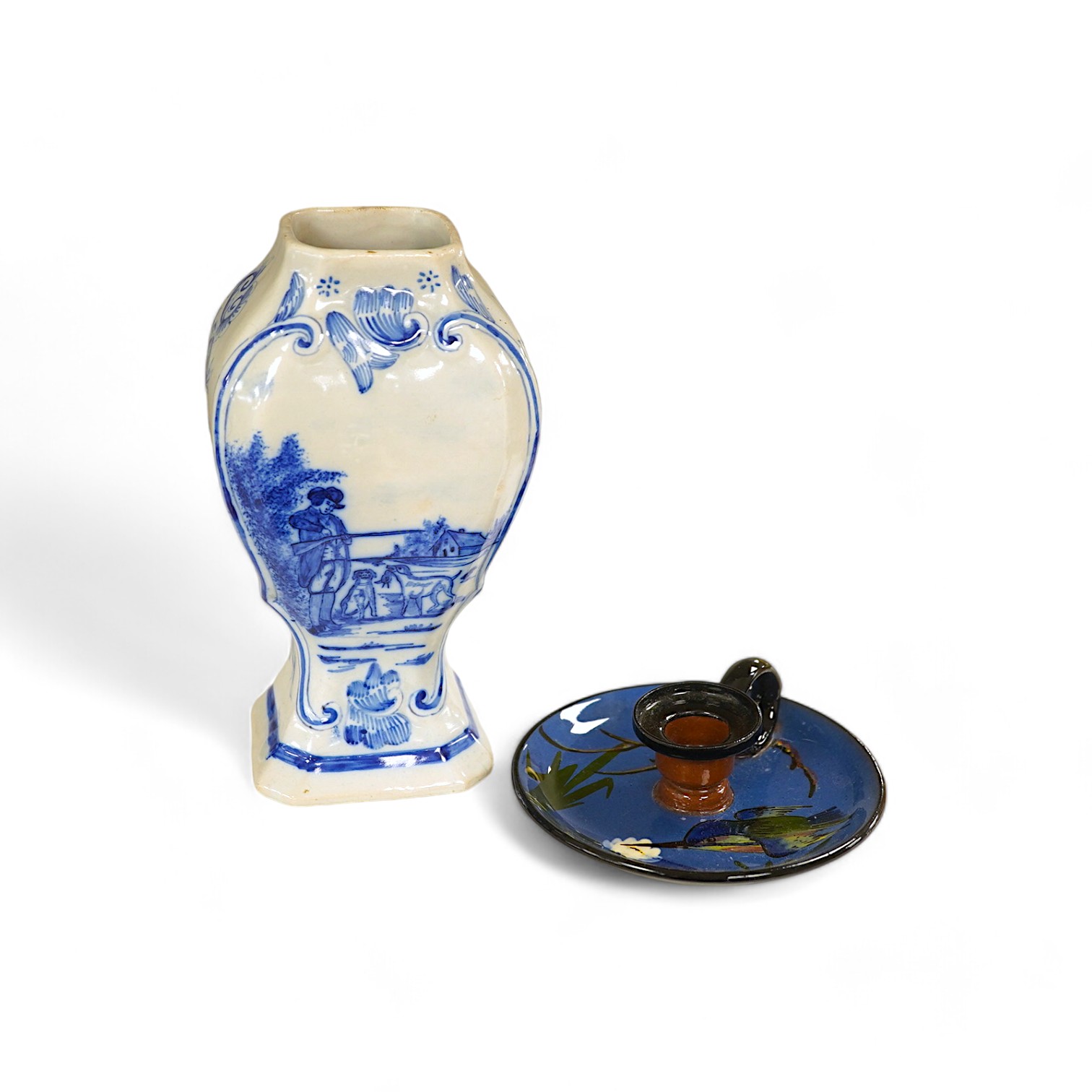 A 19th century Delft blue and white vase and a Watcombe Torquay pottery chamberstick, 19.5cm. Condition - both fair